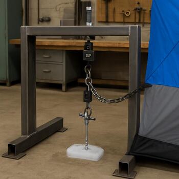 Anchor torque cradle holding an ice anchor between two frozen blocks