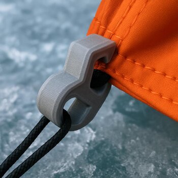 3D printed clips and mounts attached to a sled rail on frozen lake ice
