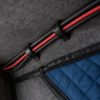 Cable clips holding LED and camera cables along the roof ribs of a shelter